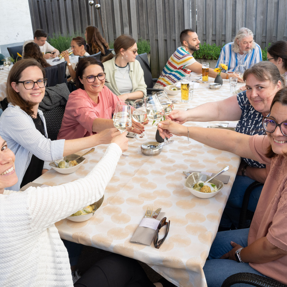 Frauen stoßen mit einem Gläschen Wein an