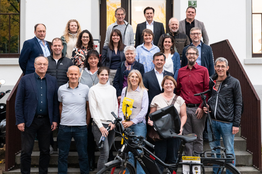 Gruppenfoto mit Gewinner:innen und deren Preisen und Vertreter:innen der Gemeinden bei der Preisverleihung