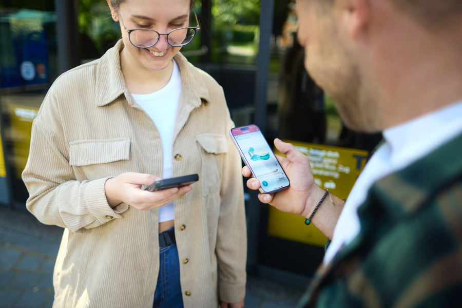Personen mit Handy vor Bus
